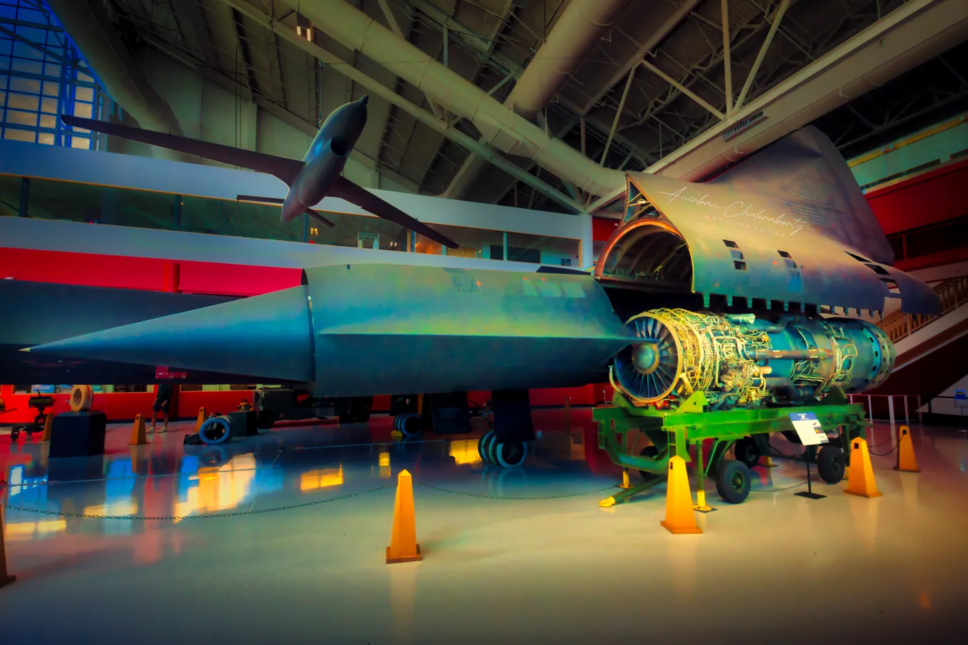 A reconnaissance jet beside its own engine, lifted out onto a stand