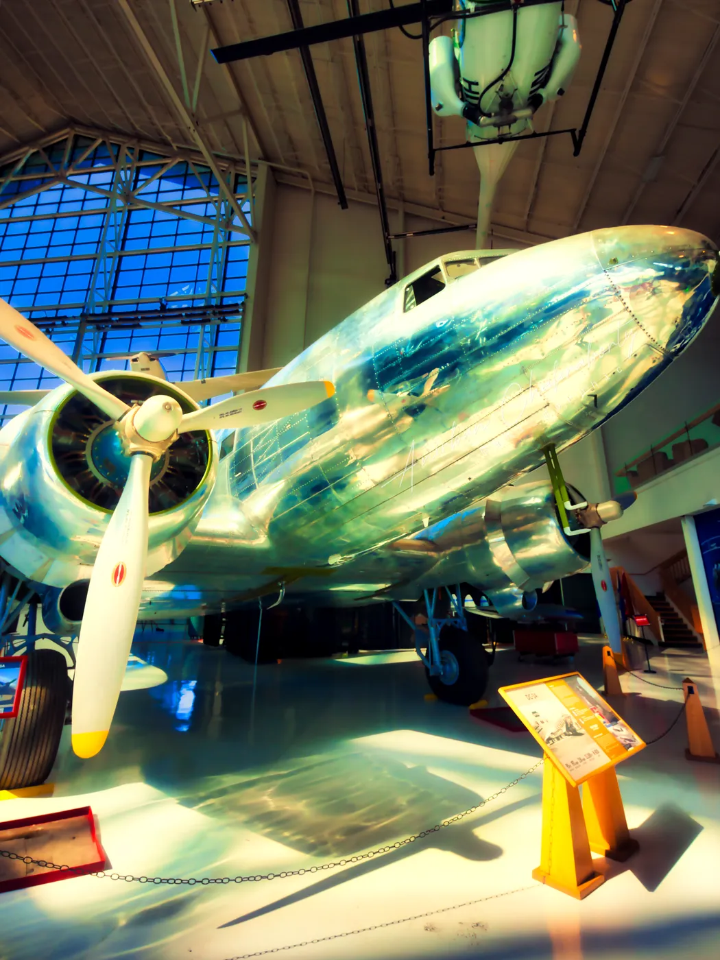 Polished aluminium and a bare radial engine under the hangar windows