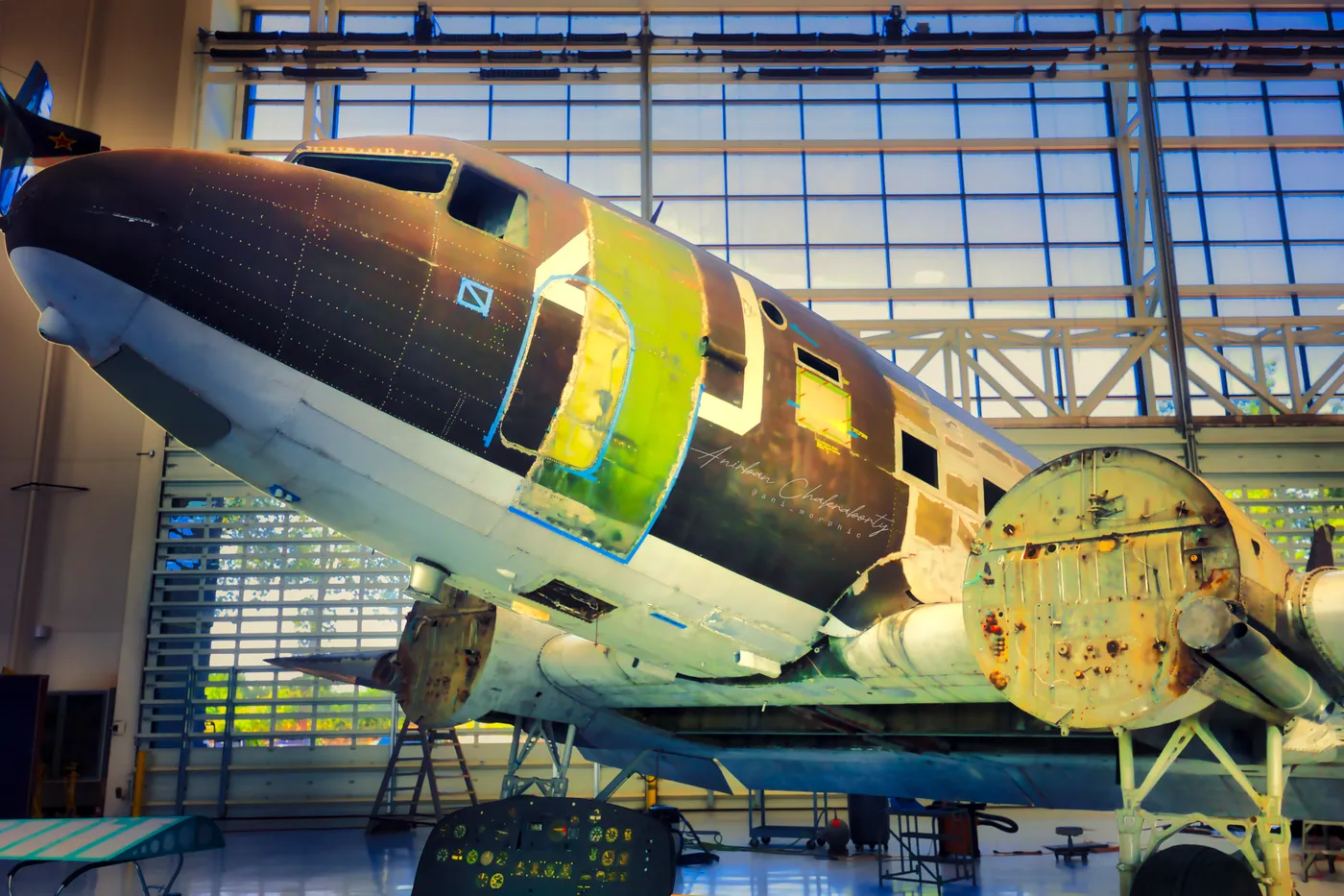 A DC-3 part-way through restoration, paint stripped back to patchwork