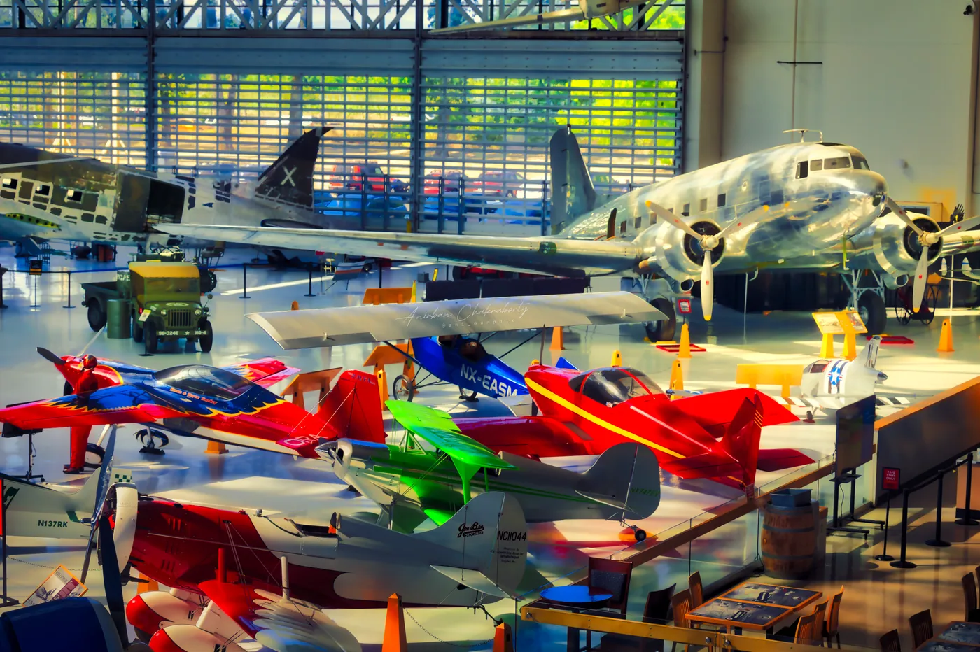 Aerobatic colour in front, a silver DC-3 holding the back of the room