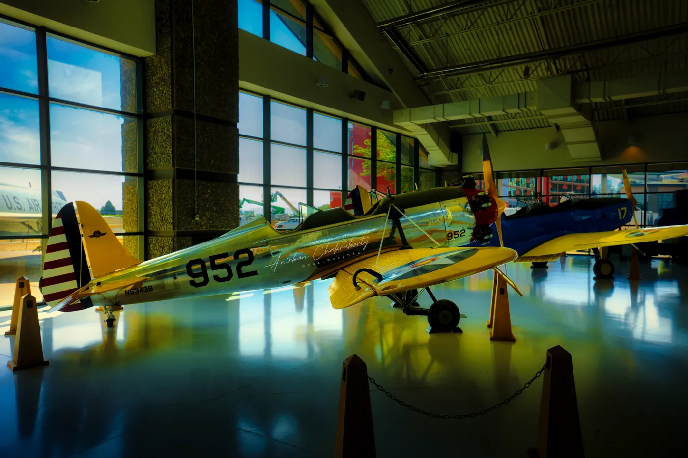 A yellow-nosed trainer, 952, against the hangar's window wall