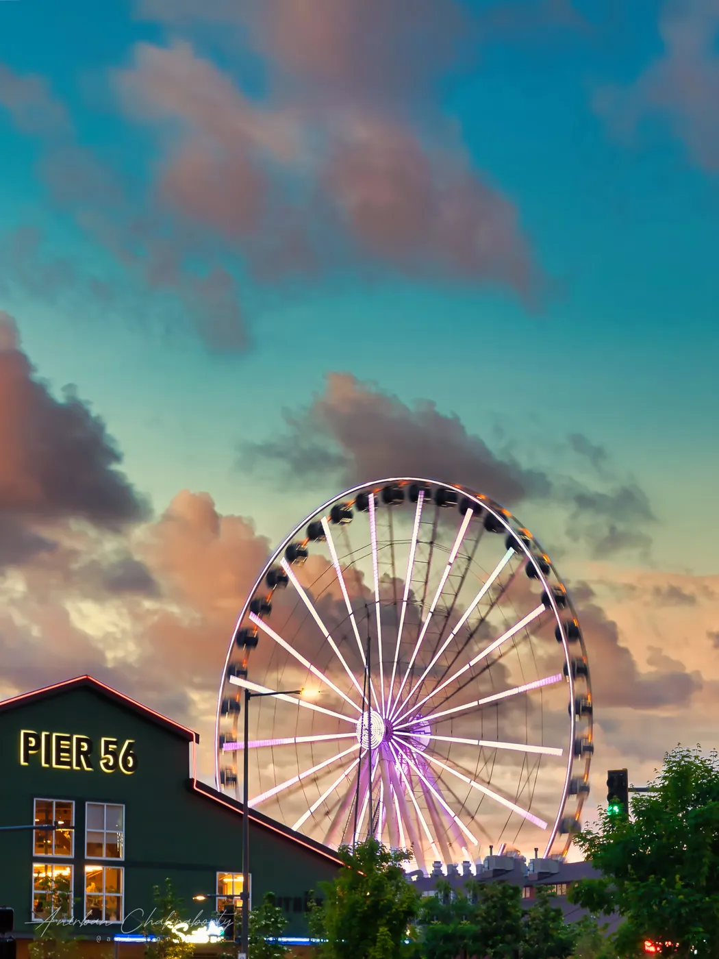 The wheel above the waterfront piers in the last of the evening